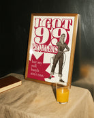 A framed poster depicting a soft butch wearing jeans and a shirt, holding a drill with the text: “I GOT 99 PROBLEMS” and “but my soft butch ain't one.”