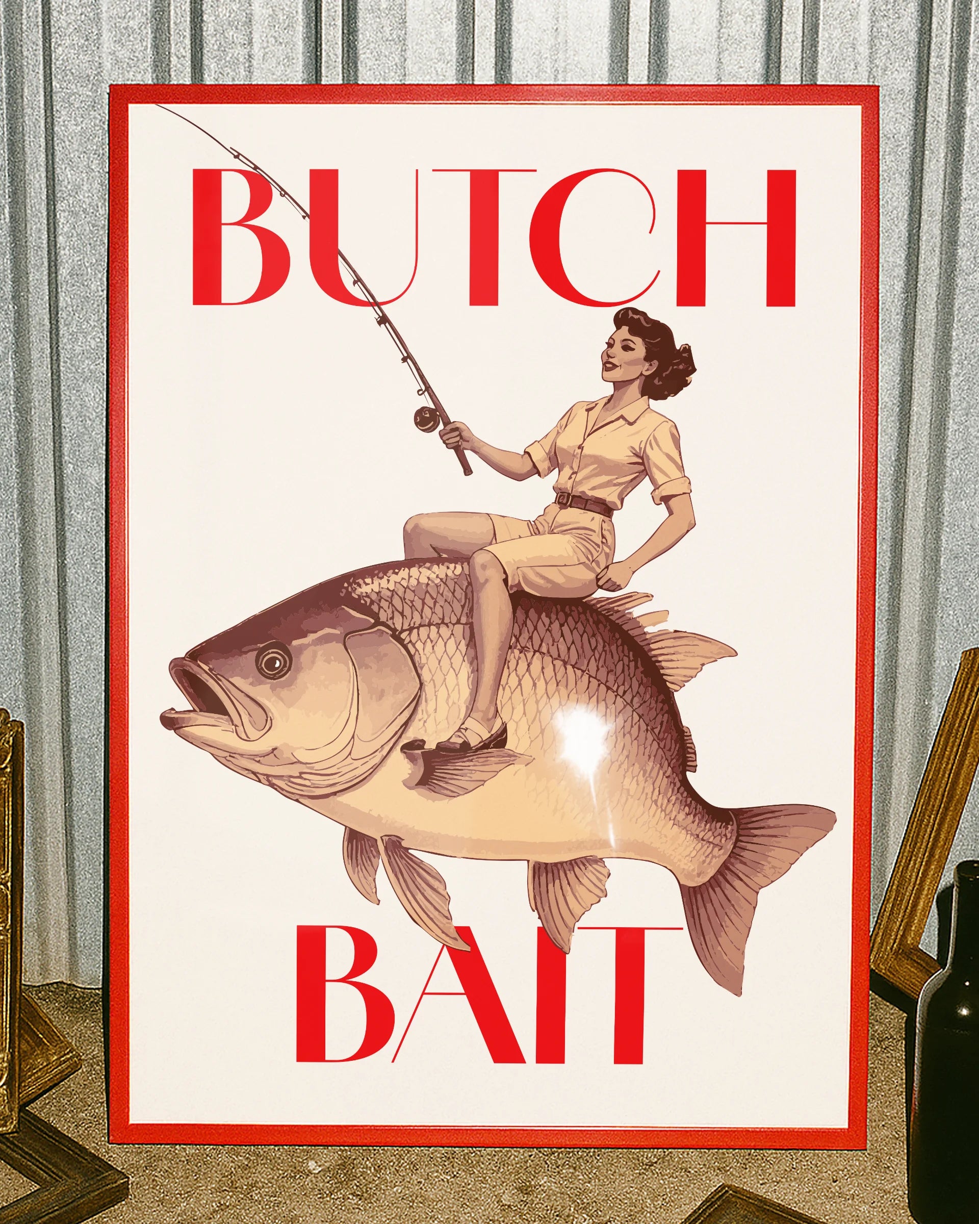 A poster depicting a lesbian woman riding a fish and holding a fishing rod, with the text ‘BUTCH BAIT'.