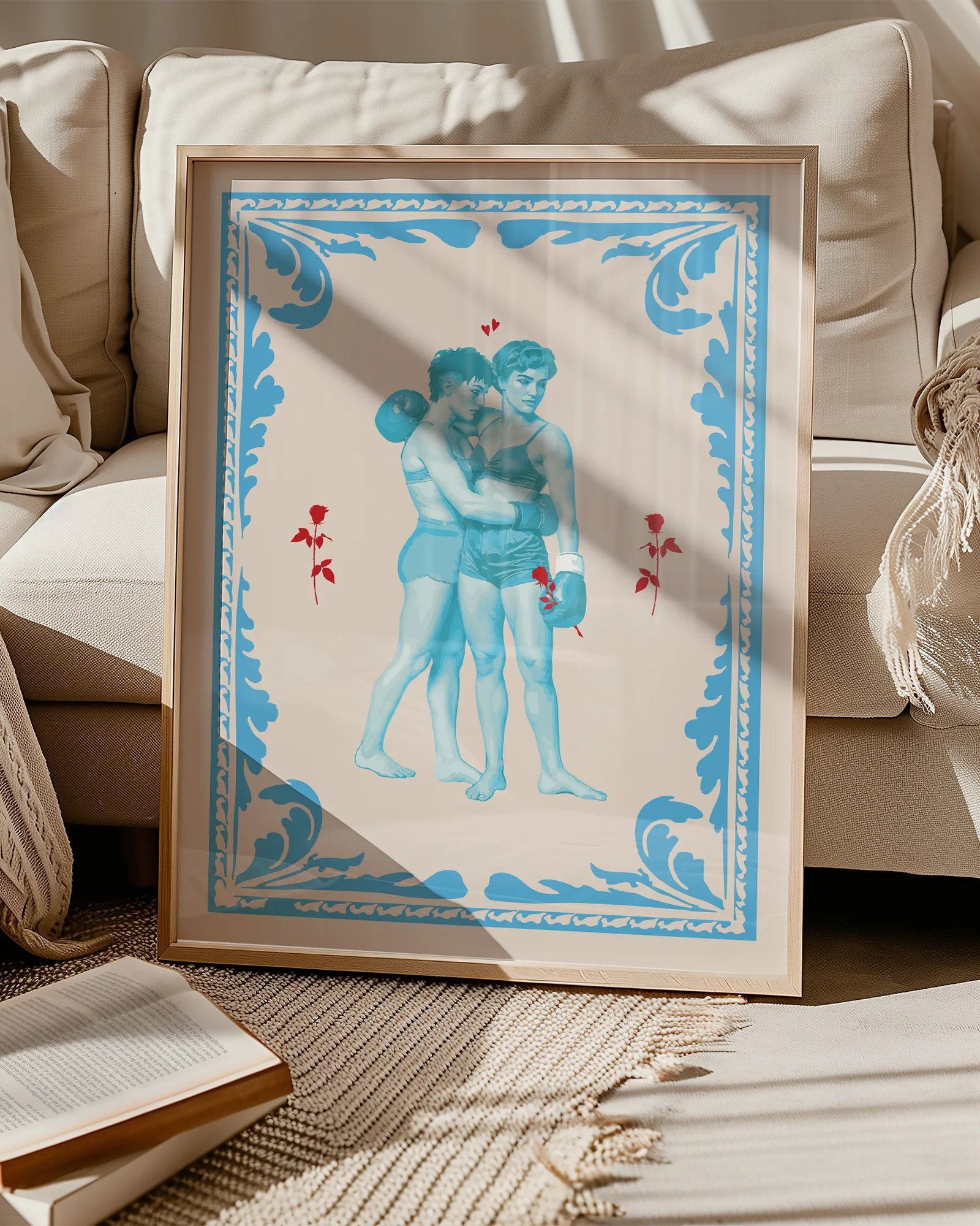 A poster that depicts two queer, muscular boxers in a romantic embrace, surrounded by red roses and a blue frame.