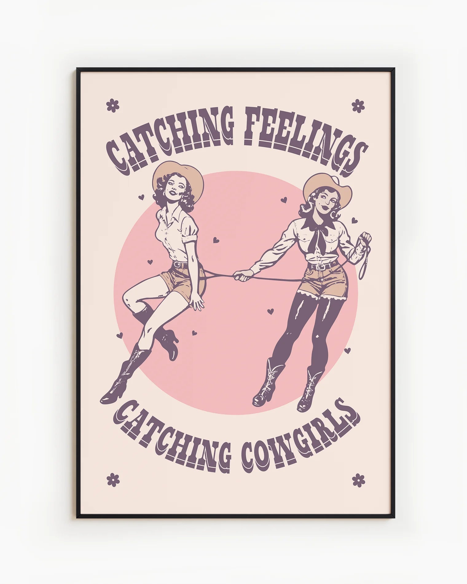 The poster features two illustrated, dreamy retro-style cowgirls capturing each other with a lasso, alongside the text: “Catching Feelings Catching Cowgirls.”