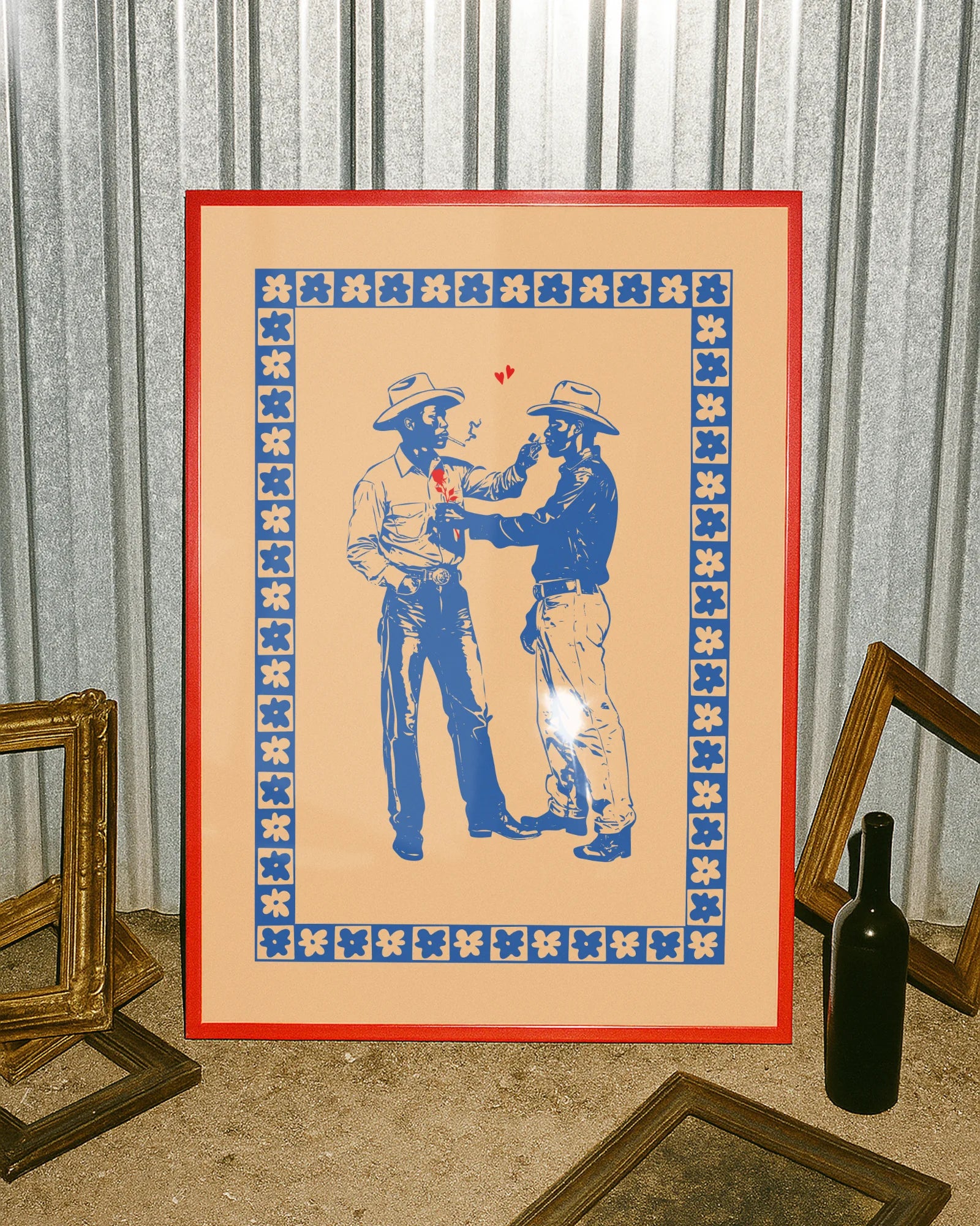 A print with two illustrated cowboys in love, against a beige background.