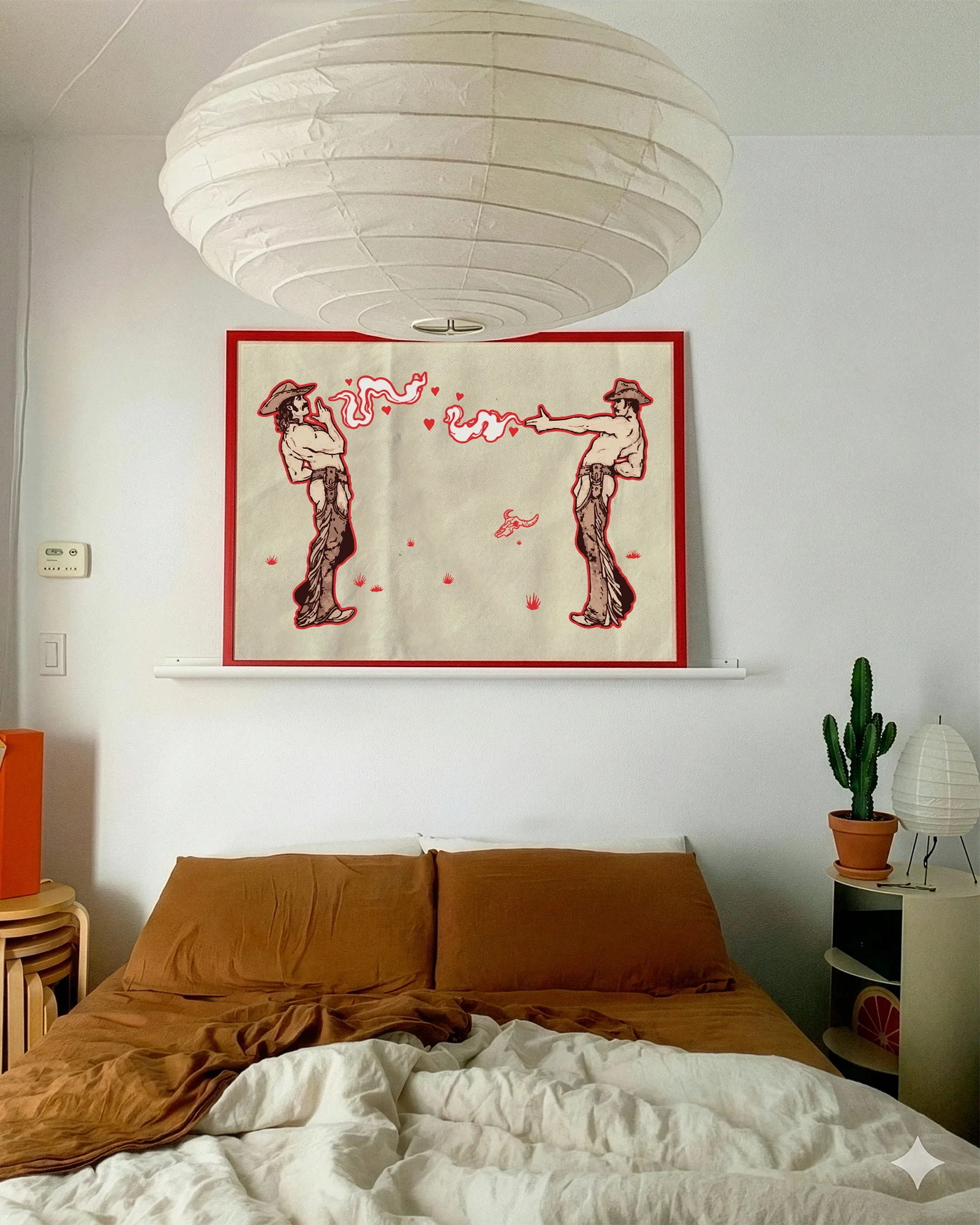 A framed poster with two gay cowboys.