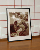 A poster featuring a fabulous drag queen in a sparkly dress, big wig, and dramatic makeup — right in the middle of a tire change.