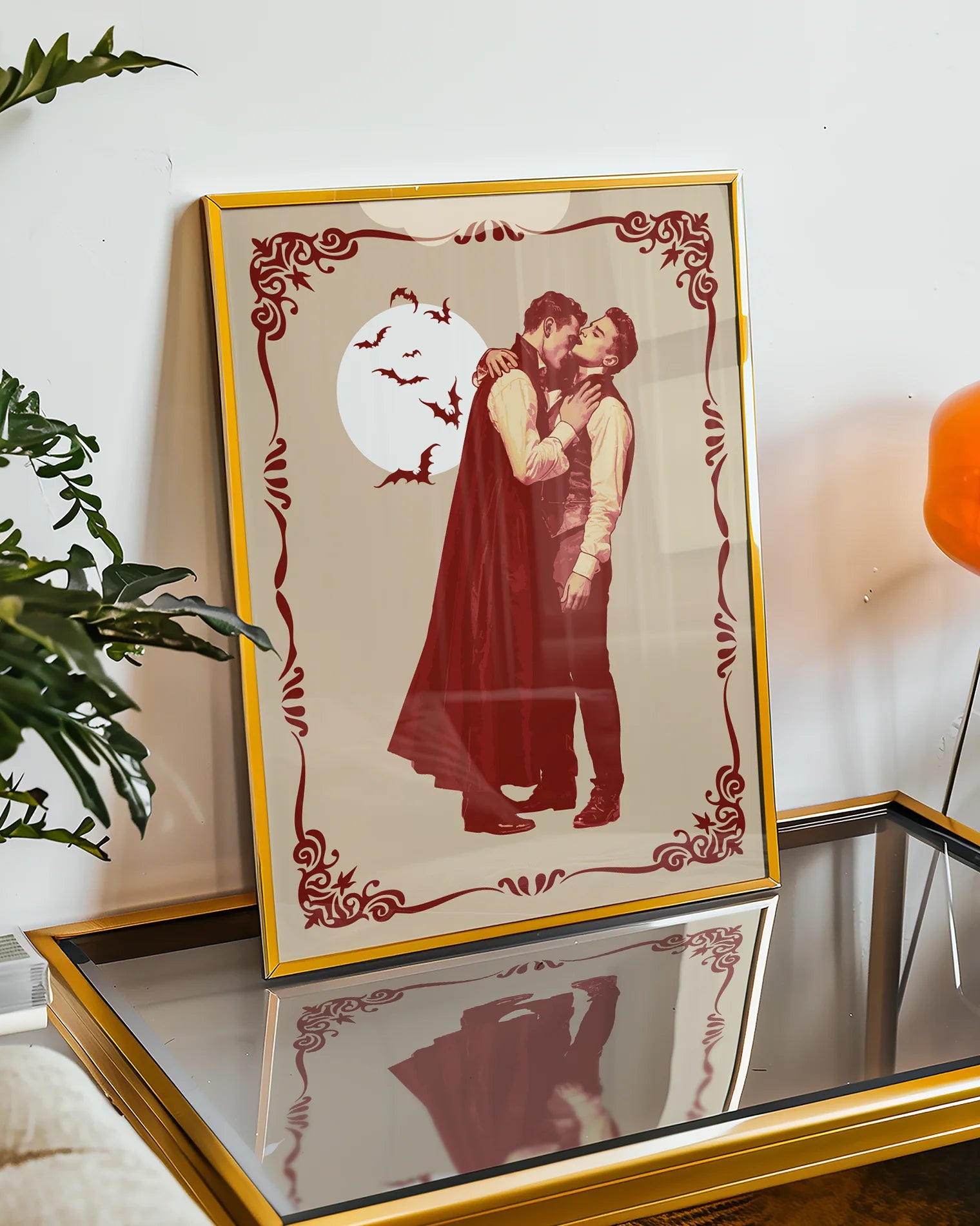 A poster featuring a male vampire kissing another man’s neck, framed by a vintage border, with a full moon and flying bats in the background.
