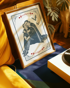 A poster depicting two male vampires embracing each other in a romantic hug, surrounded by a webbed frame, a large white moon, red roses, and flying bats.