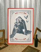A poster depicting two male vampires embracing each other in a romantic hug, surrounded by a webbed frame, a large white moon, red roses, and flying bats.