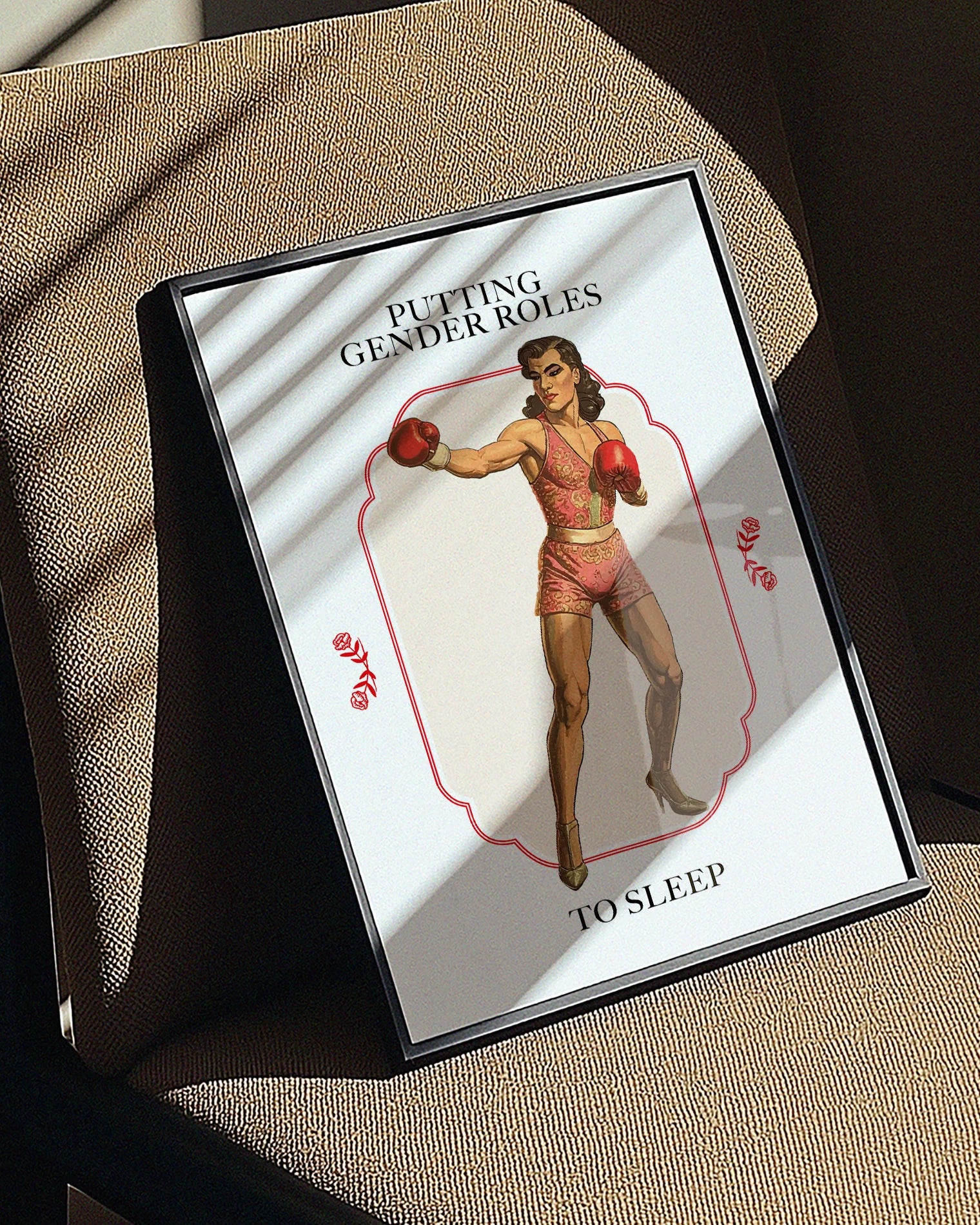A poster featuring a muscular male boxer in makeup and pink clothing, with the text 'PUTTING GENDER ROLES TO SLEEP'.