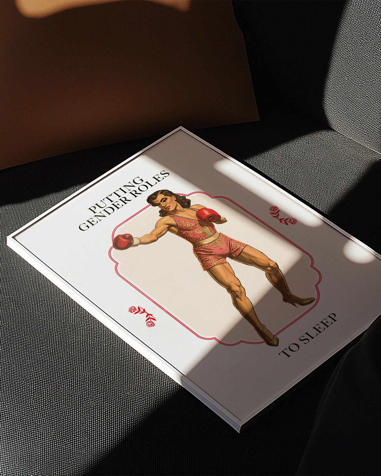 A poster featuring a muscular male boxer in makeup and pink clothing, with the text 'PUTTING GENDER ROLES TO SLEEP'.