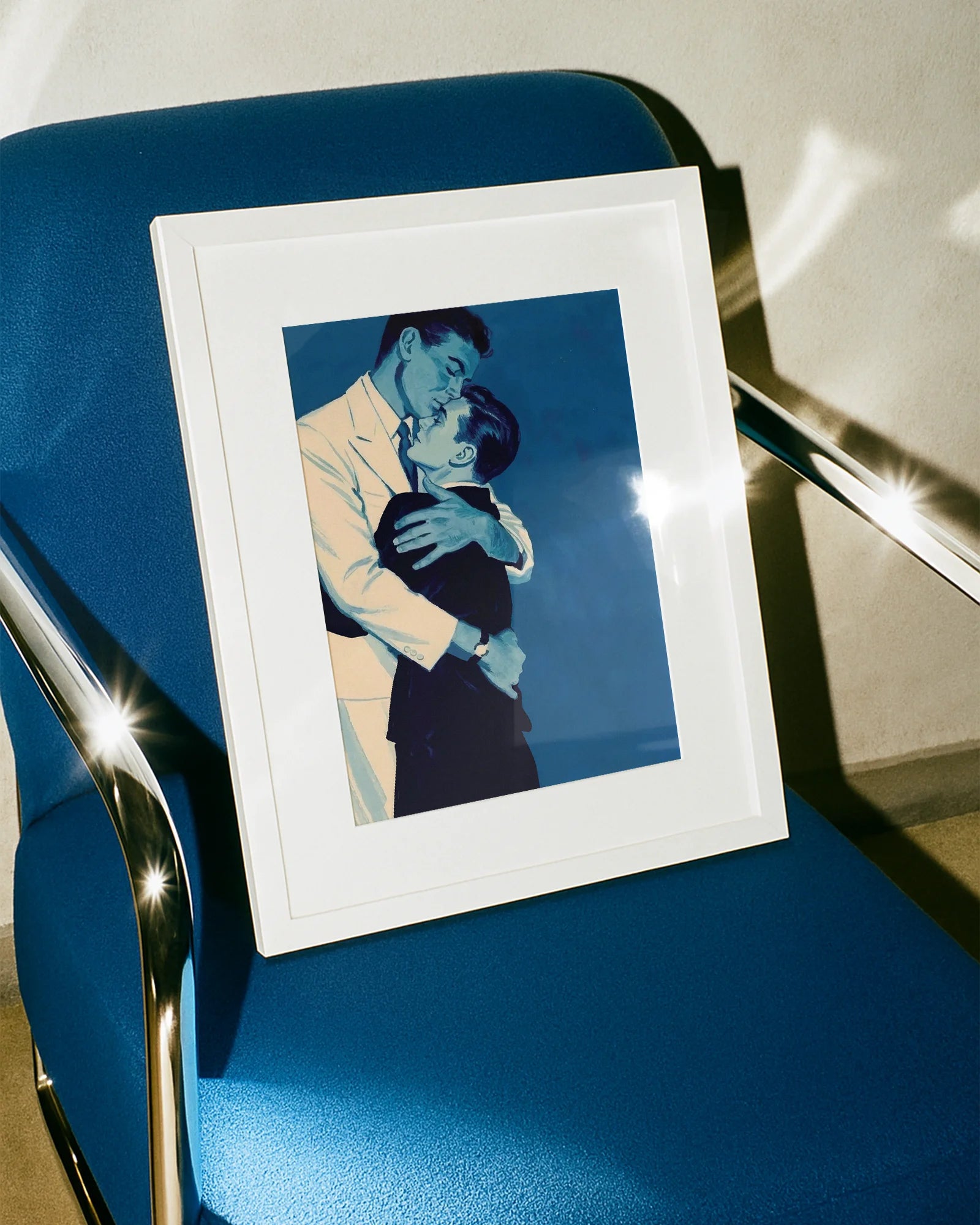 A framed print with two gay men hugging tightly, vintage 1940's style.