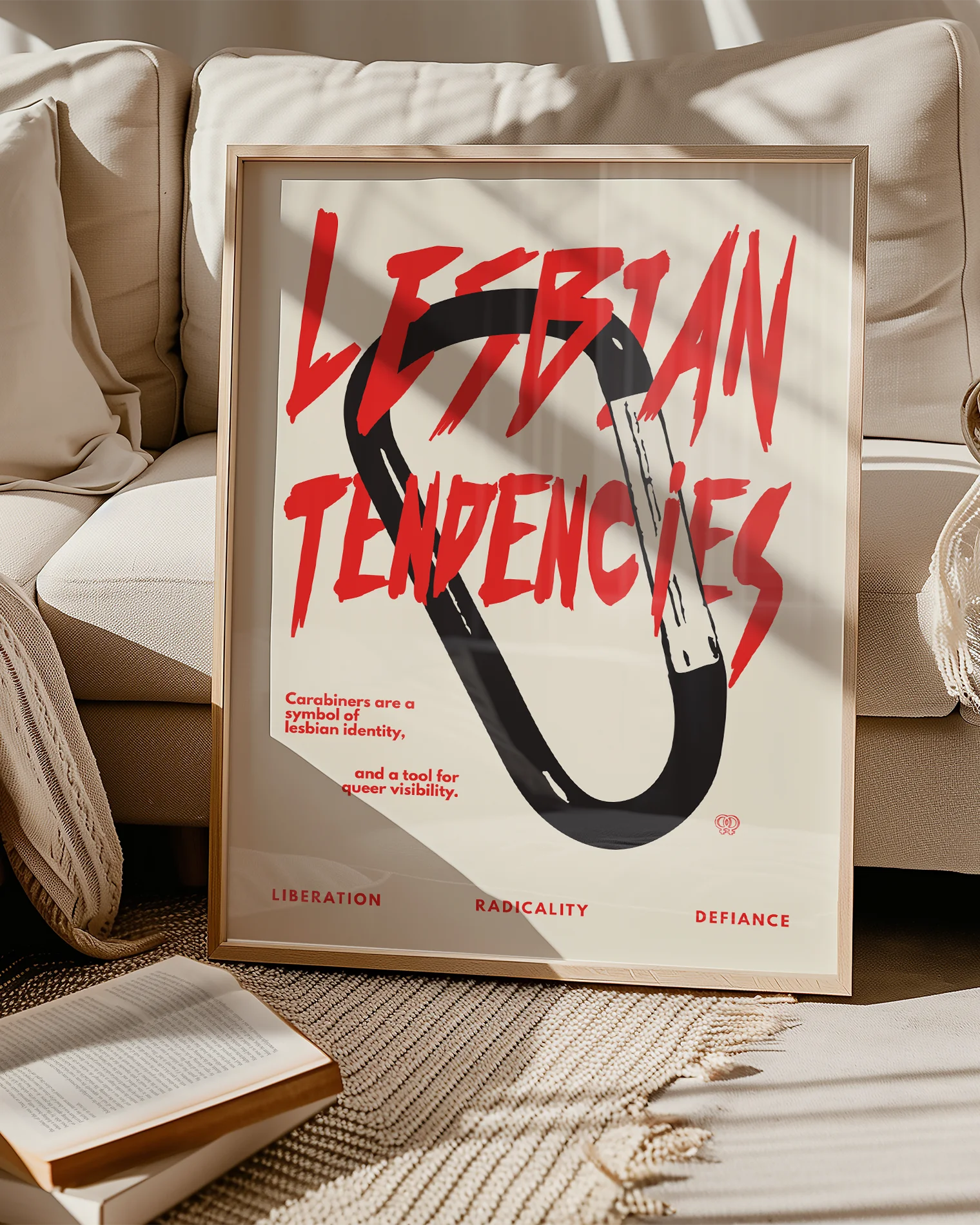 A print with an illustrated carabiner, with the text 'Lesbian Tendencies' in red.