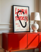 A print with an illustrated carabiner, with the text 'Lesbian Tendencies' in red.