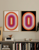 Two framed prints with a lesbian, illustrative flag in an oval form.