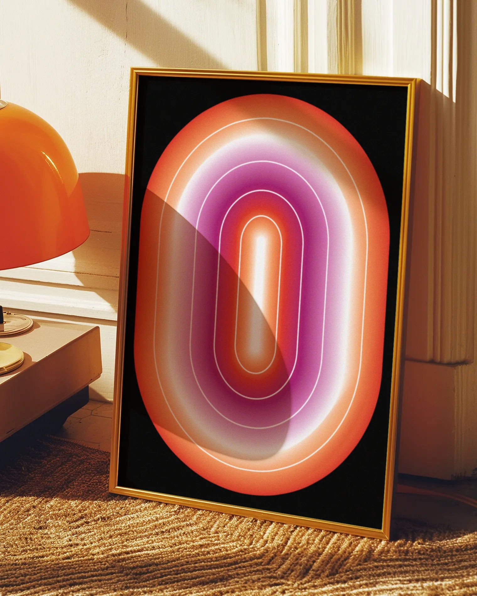 A framed print with a lesbian, illustrative flag in an oval form.