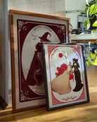 Two posters with a lesbian vampire couple.