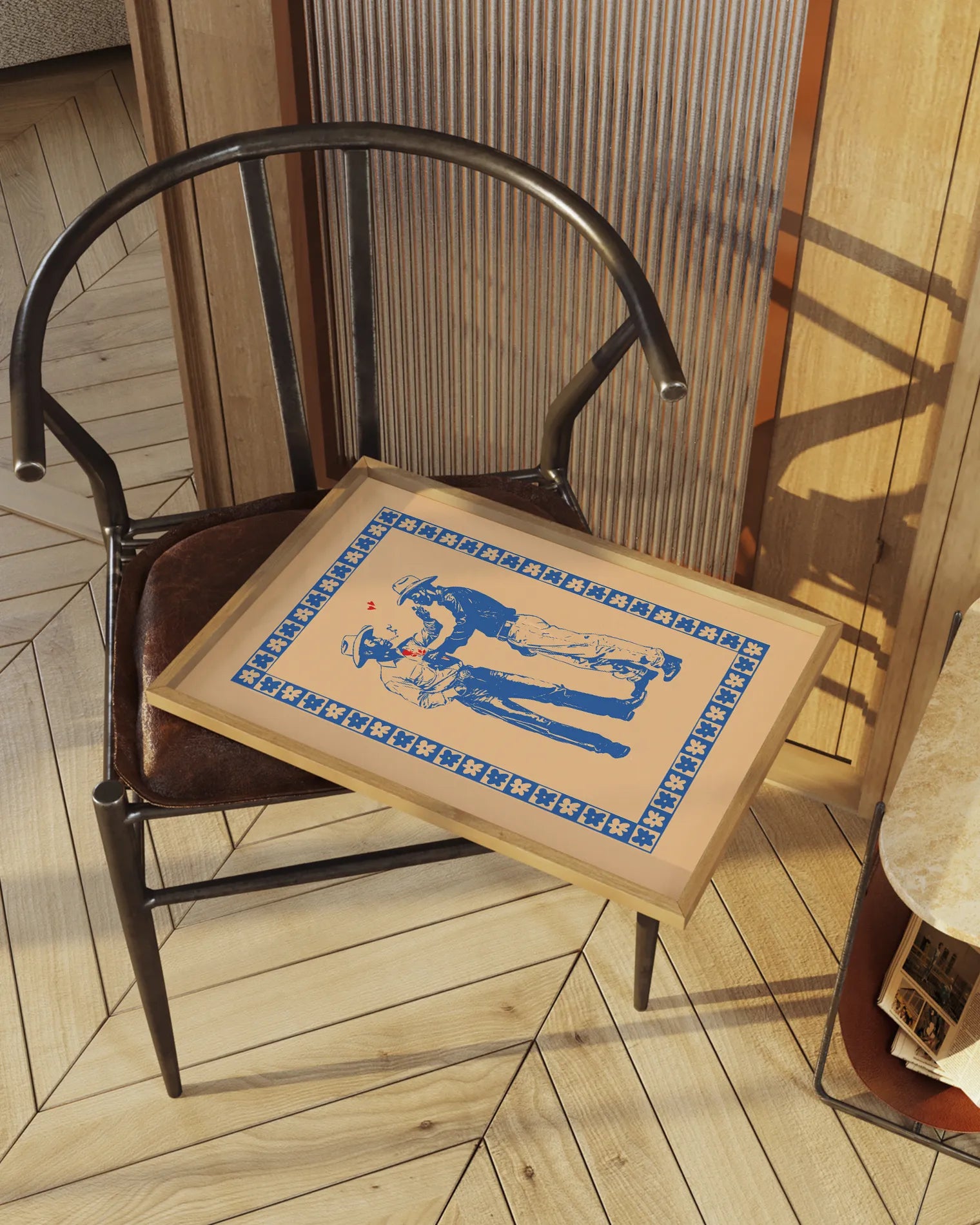 A print with two illustrated cowboys in love, against a beige background.