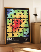 A print with the classic pride flag colours in abstract, rounded forms with the text 'Love Is Boundless.'