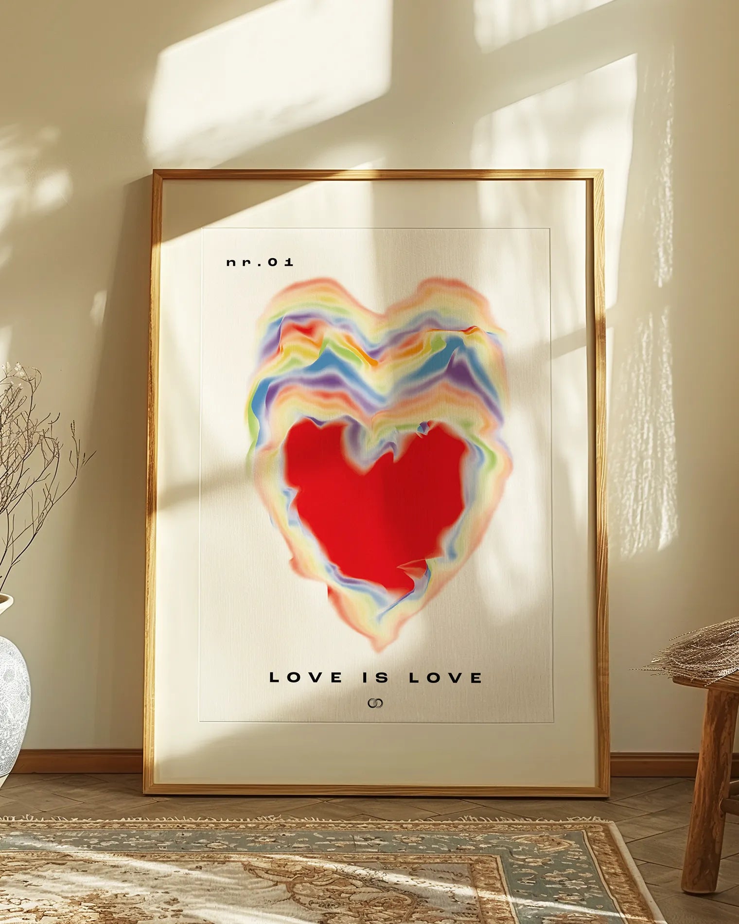 Framed poster with a burning heart in pride rainbow colours with the text 'LOVE IS LOVE'.