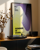 A poster features circular shapes in the non-binary flag’s colors, yellow, white, purple, and black, with the text: '004. The Gradient Collection', 'Gender is Over', and 'Beyond the Binary.'.