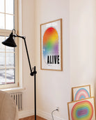 A print with the classic pride colours in an oval shape with the text 'Pride Keeps People Alive'.