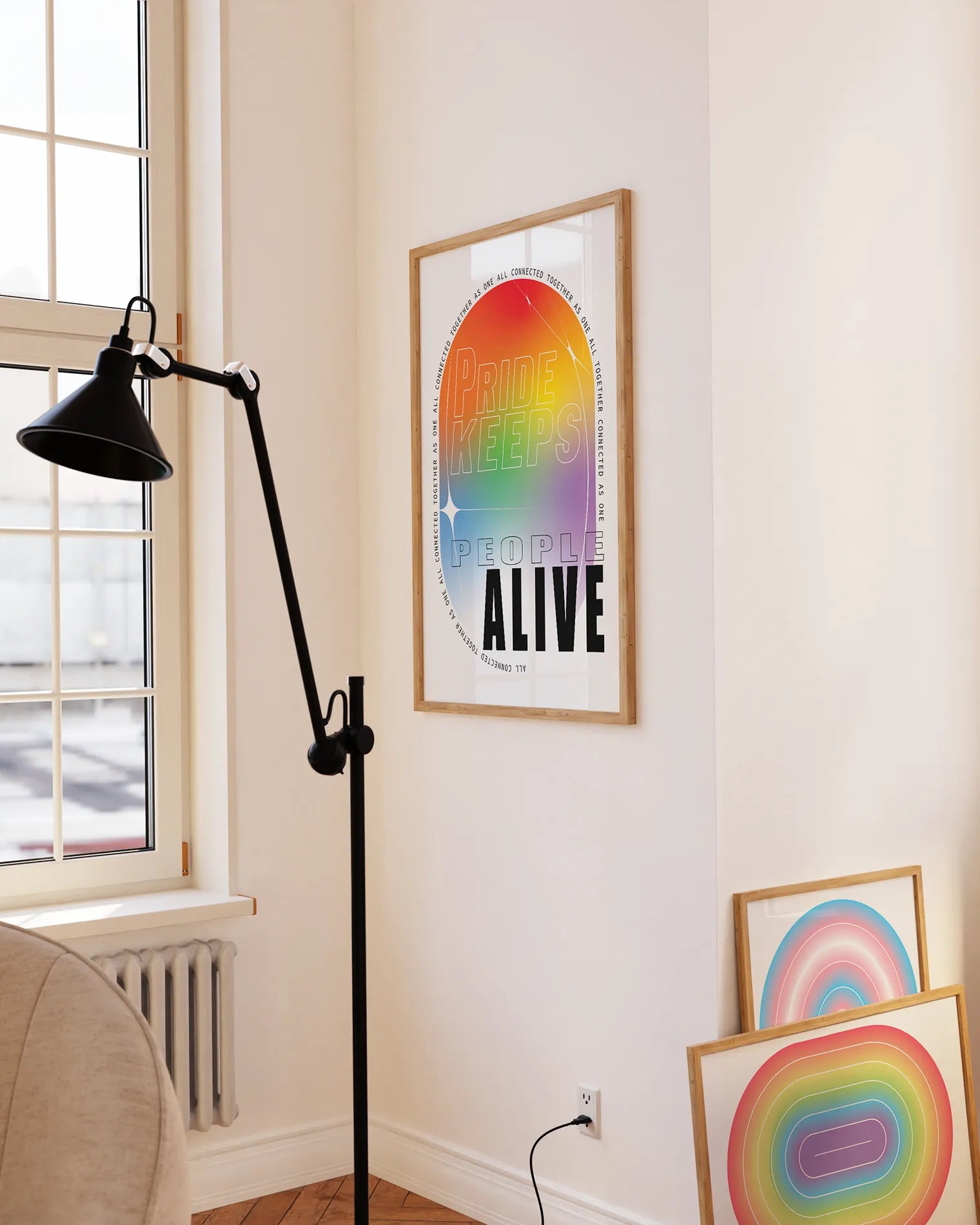 A print with the classic pride colours in an oval shape with the text 'Pride Keeps People Alive'.