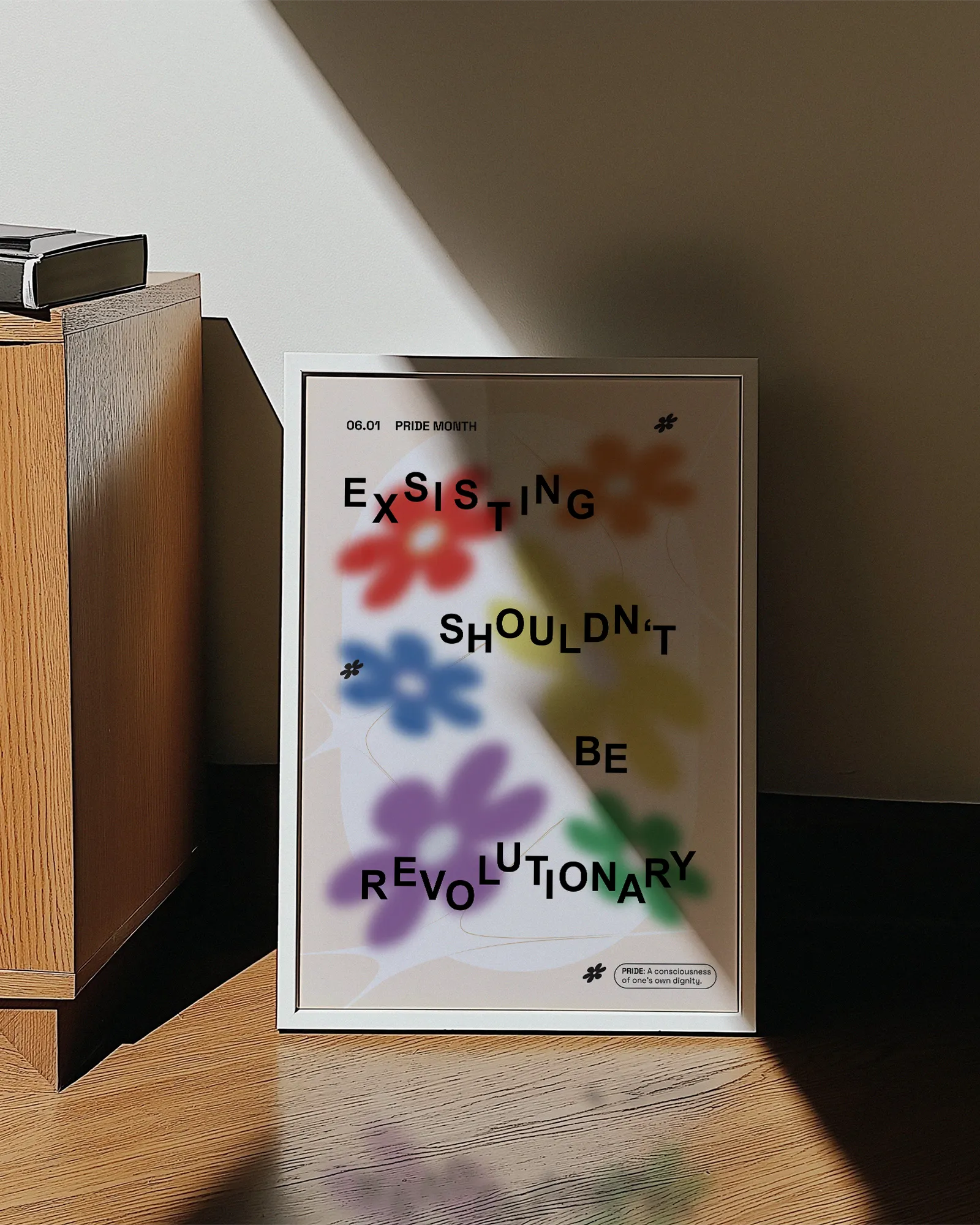 A print with gay pride flowers and the text 'Existing Shouldn't Be Revolutionary'.