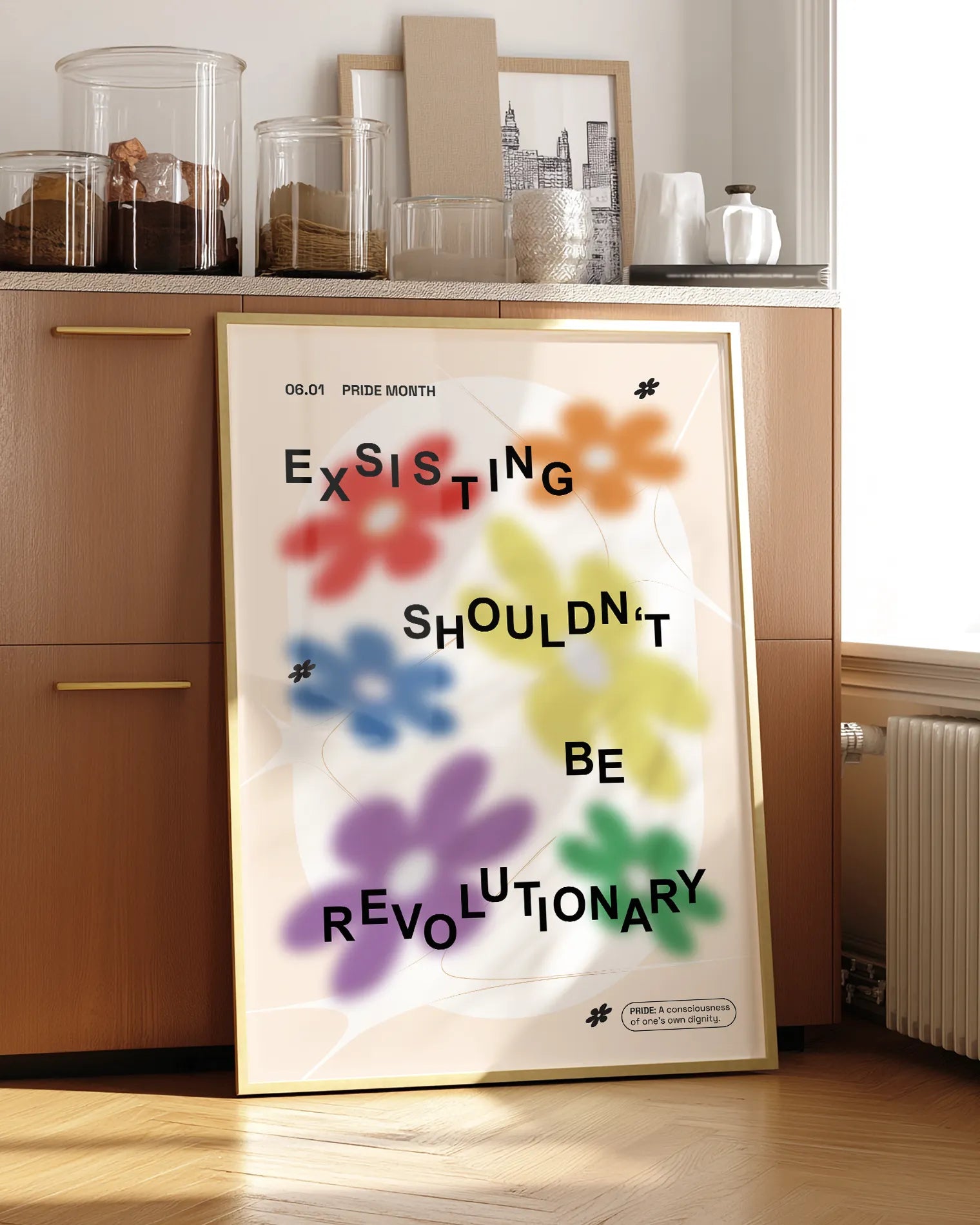 A print with gay pride flowers and the text 'Existing Shouldn't Be Revolutionary'.