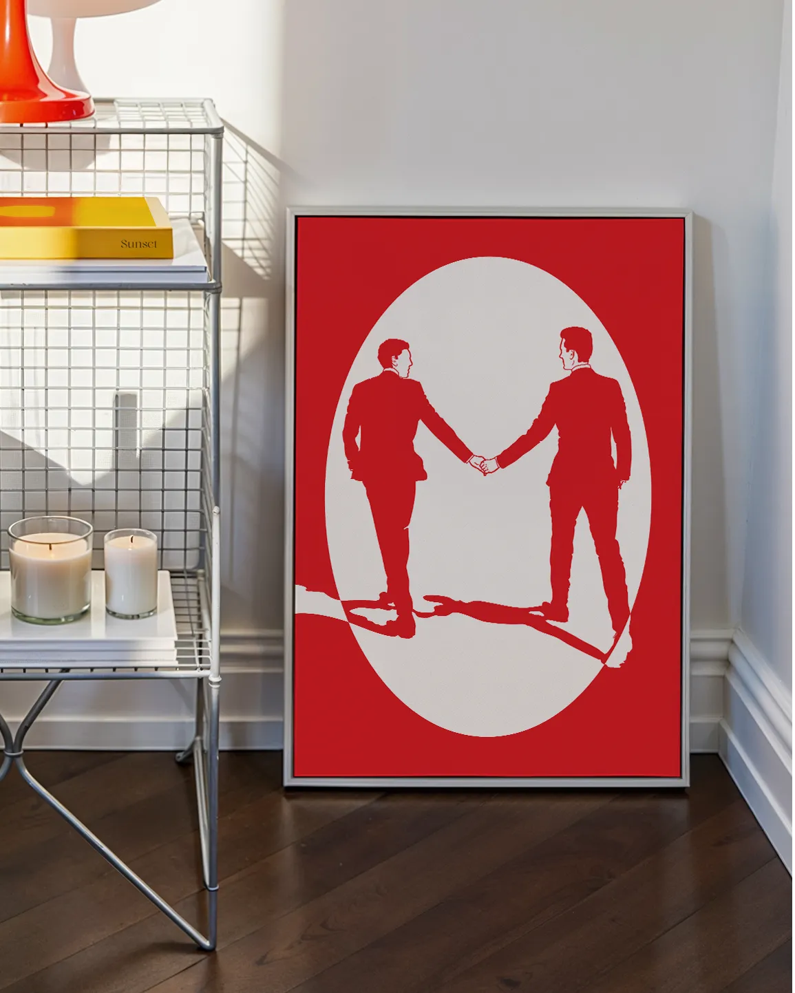 A print with an illustrated male couple in suits, walking hand in hand against a red background.