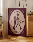 A print with two illustrated lesbian cowgirls in a loving, playful pose.