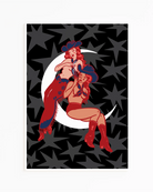 A print with two illustrated, sapphic cowgirls sitting on a moon.