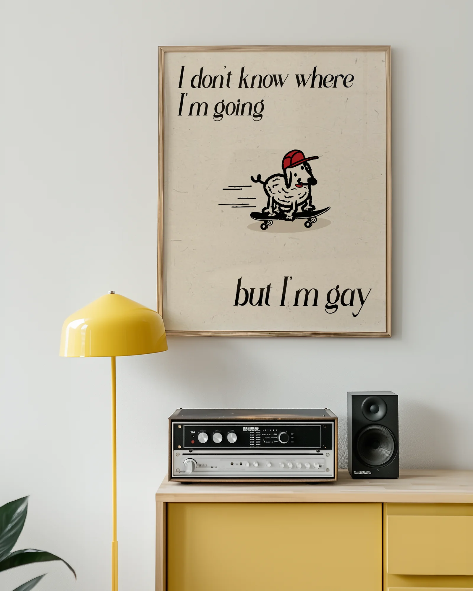 A framed poster with a cute, curly dog on a skateboard with the text 'I don't know where I'm going but I'm gay.