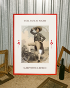A poster featuring a charming butch dyke in a suit and hat, with the text 'FEEL SAFE AT NIGHT, SLEEP WITH A BUTCH'.