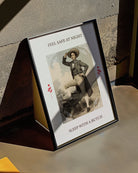 A poster featuring a charming butch dyke in a suit and hat, with the text 'FEEL SAFE AT NIGHT, SLEEP WITH A BUTCH'.