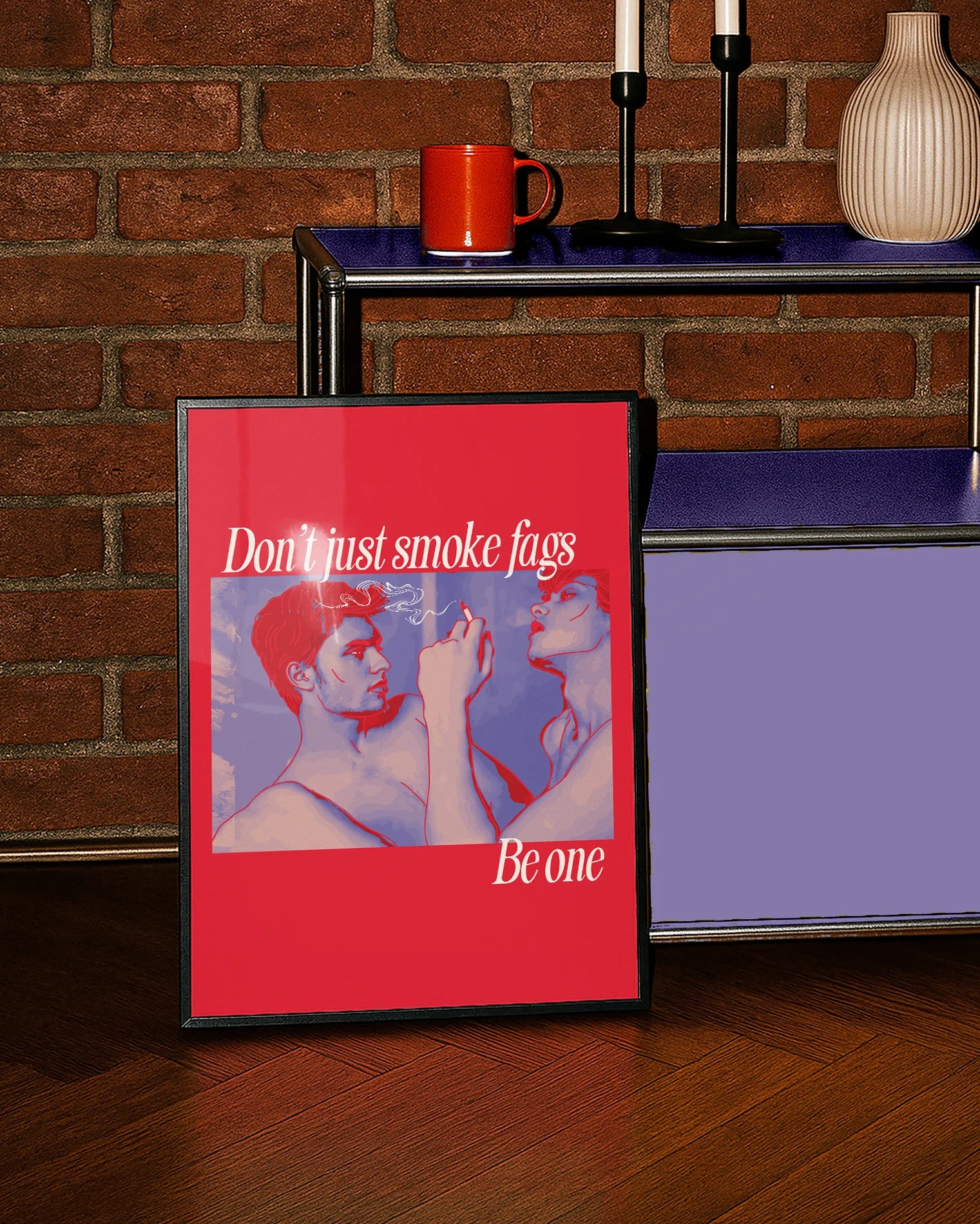 A framed poster shows two gay men, one of whom is smoking a cigarette, with the text: 'Don't just smoke fags — be one'.