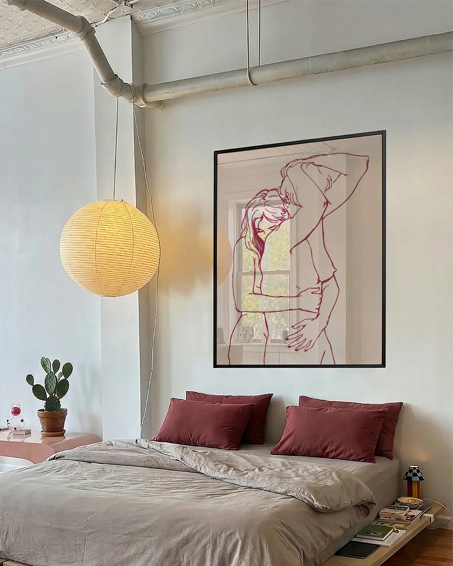 A framed print with two lesbian, naked girls hugging.