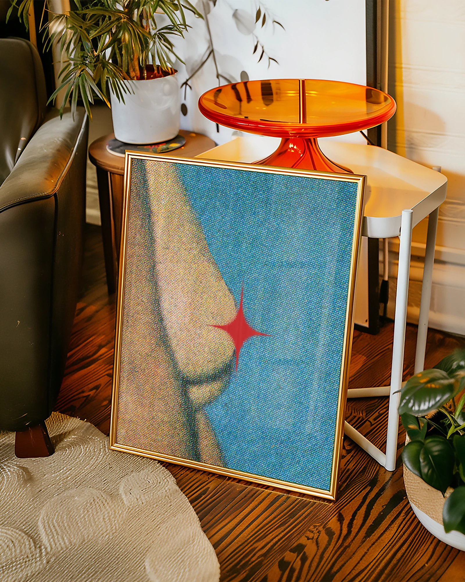 A framed poster showing female breasts coevered with a red star, abstract and grainy style.