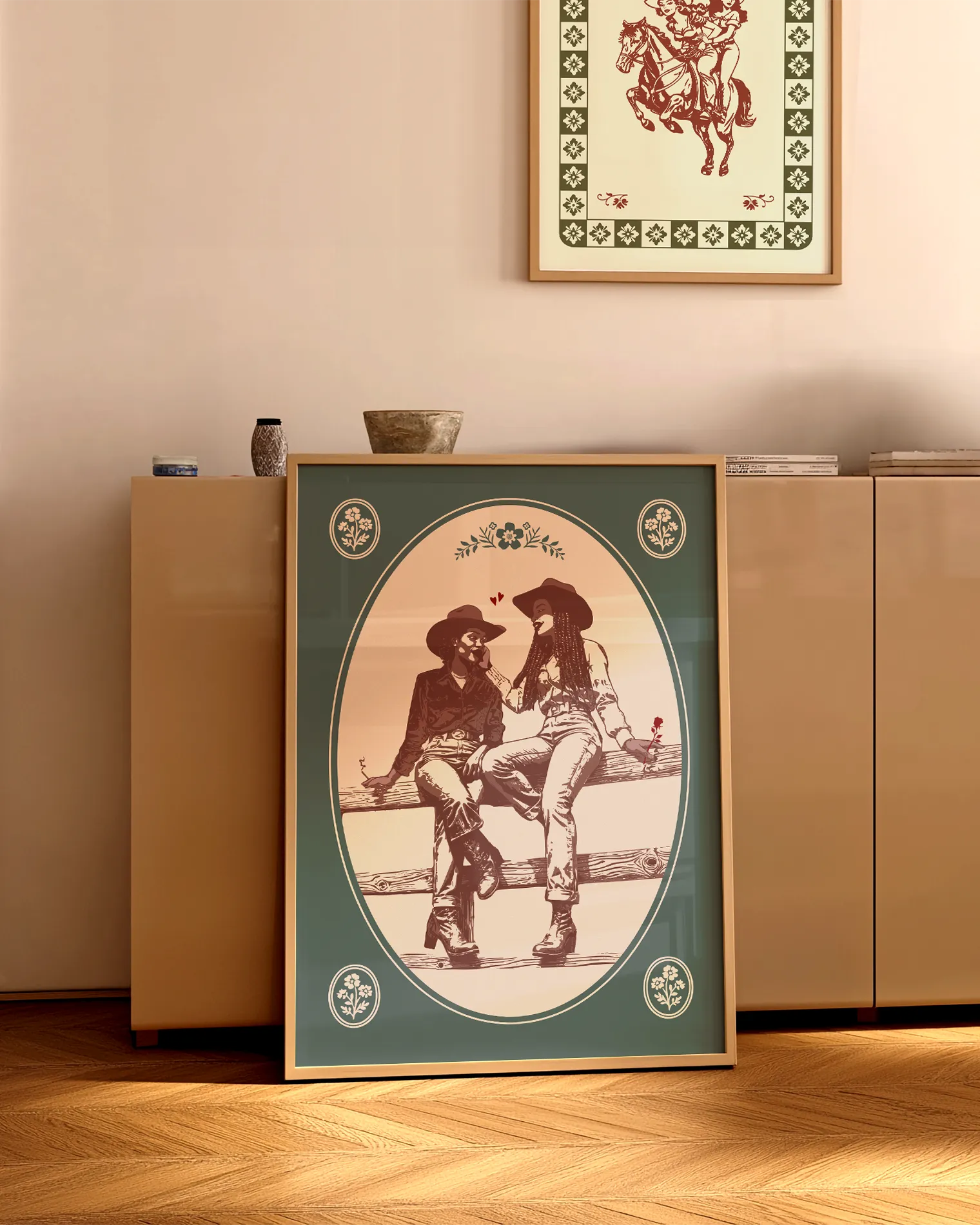 A print with an illustrated, sapphic cowgirl couple sitting on a fence.