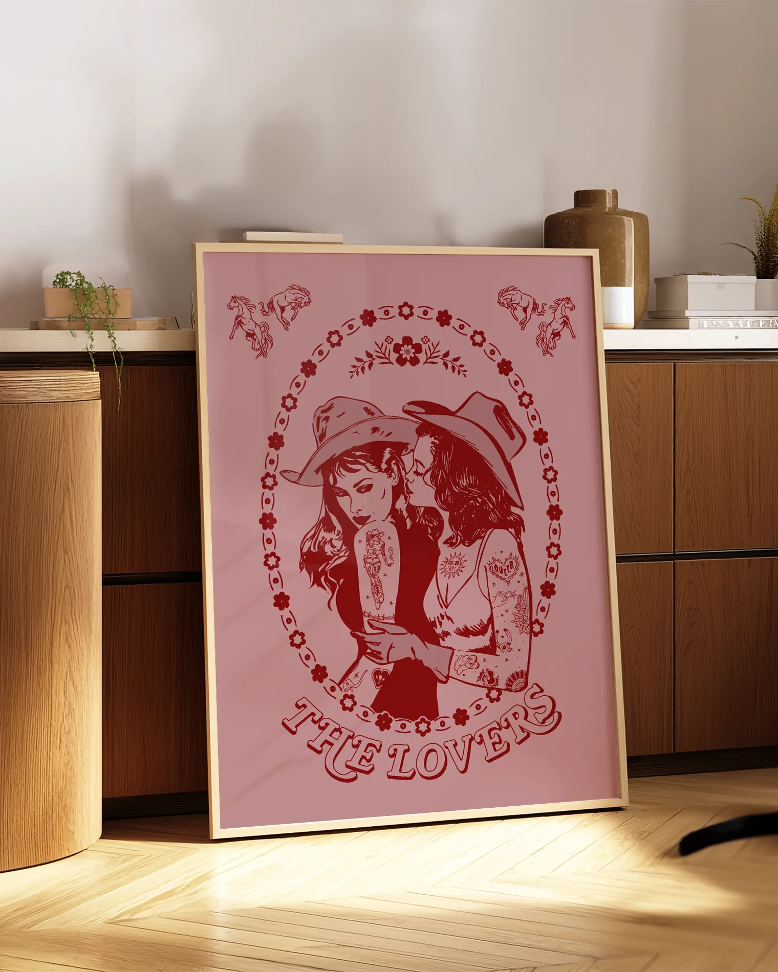 A print with a lesbian cowgirl couple kissing with the text 'The Lovers'.