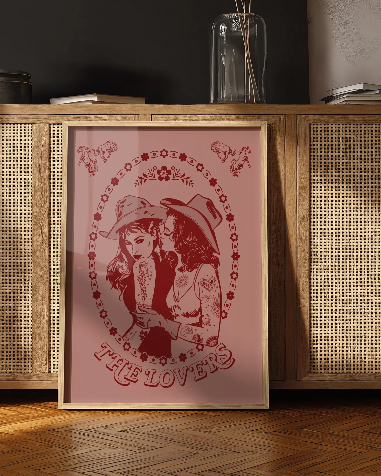 A print with a lesbian cowgirl couple kissing with the text 'The Lovers'.
