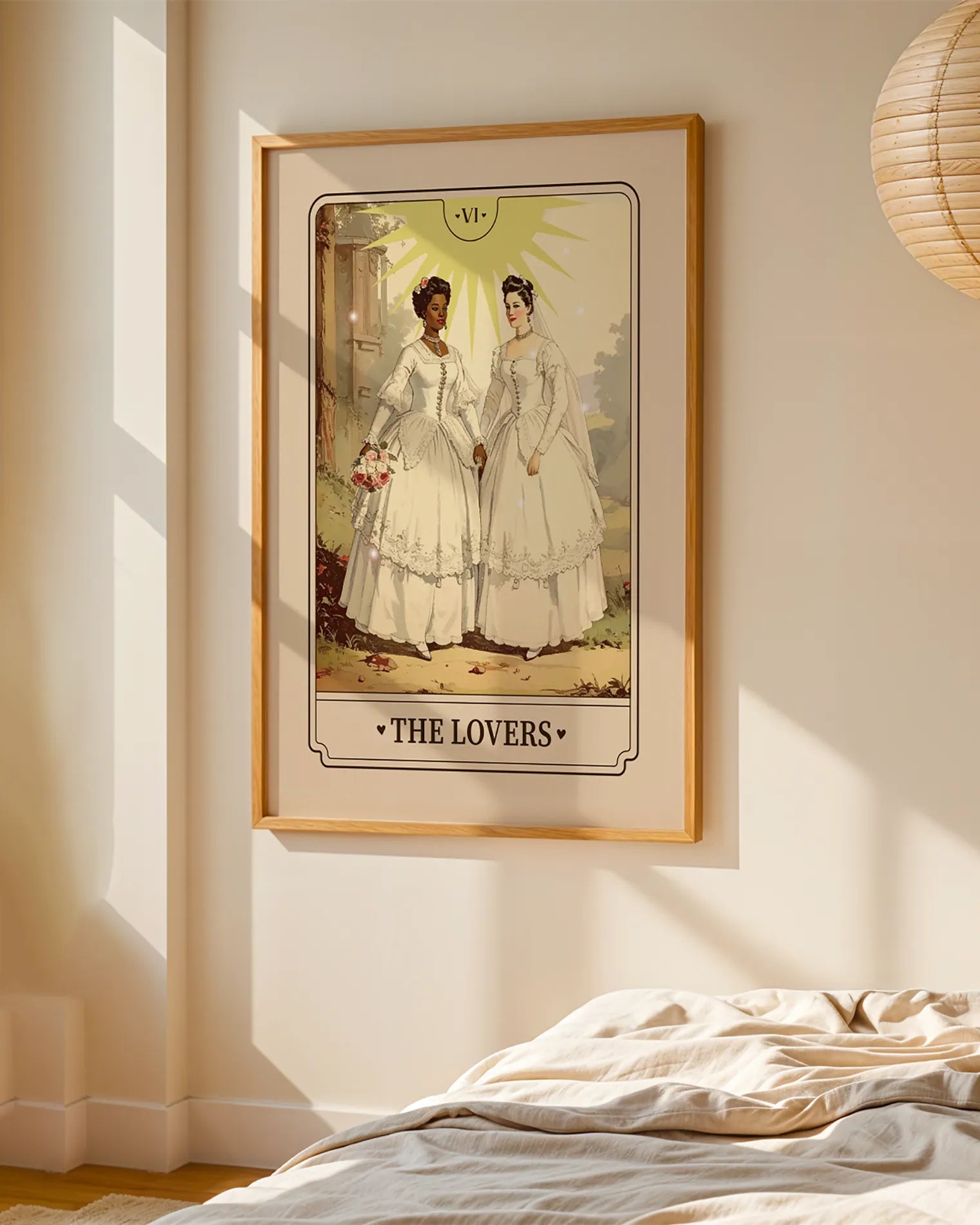A print with an illustrated, sapphic, newlywed couple in a tarot card style with the text 'The Lovers'.