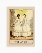 A print with an illustrated, sapphic, newlywed couple in a tarot card style with the text 'The Lovers'.