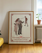 A poster with a hetero couple, a woman kissing her husband on the cheek, but the husband is looking at a young, cute man walking by with the text 'The Secret Lovers'.