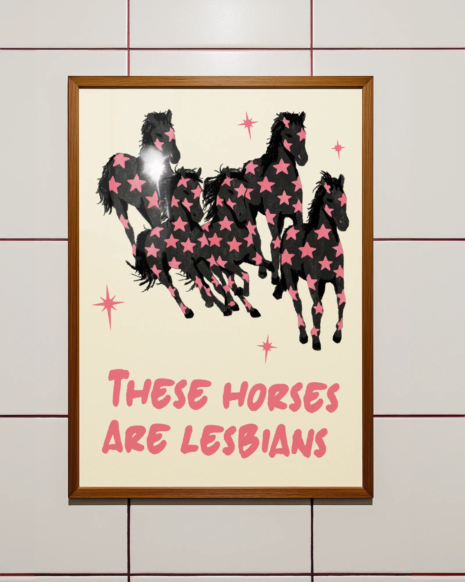 A framed poster with five horses and the text 'THESE HORSES ARE LESBIANS'.