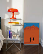 A framed print with a couple in suits, walking hand in hand in a desert.