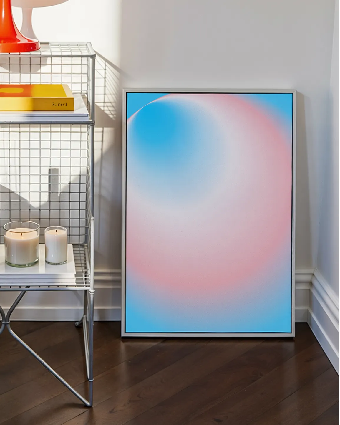 A framed print with a round, gradient form in the transflag colours blue, pink and white.