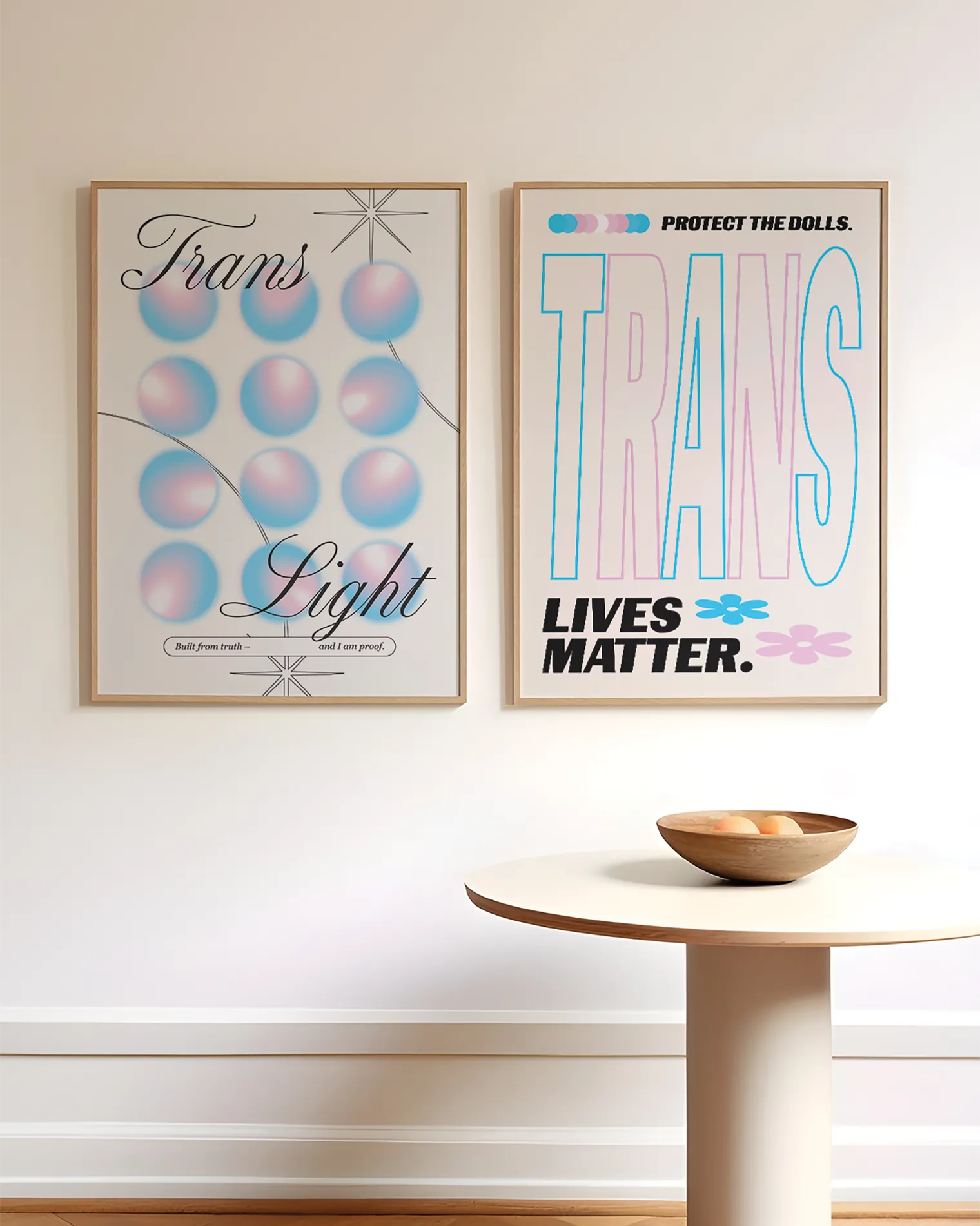 A print with the text 'Trans Light', against a background with gradient circles in the transgender flag colours.