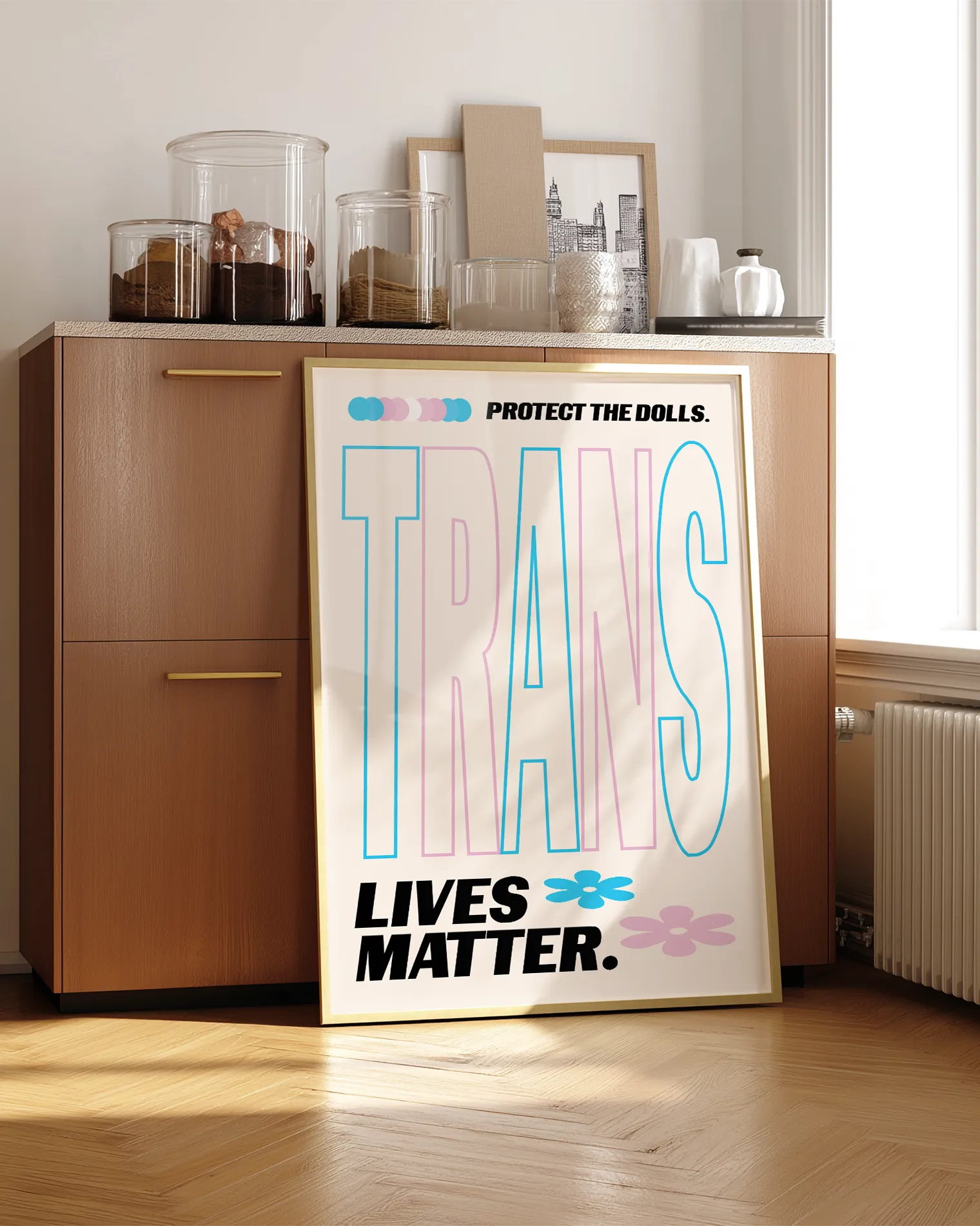A print with the text 'Trans Lives Matter', with the transgender pride flag colours.