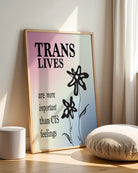 A print with the text 'Trans Lives are more important than CIS feelings', against the transgender flag colours.