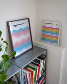 A print with the Transgender pride flag in a wavy, abstract form together with the text 'Transgender Pride Flag est. 1999.'