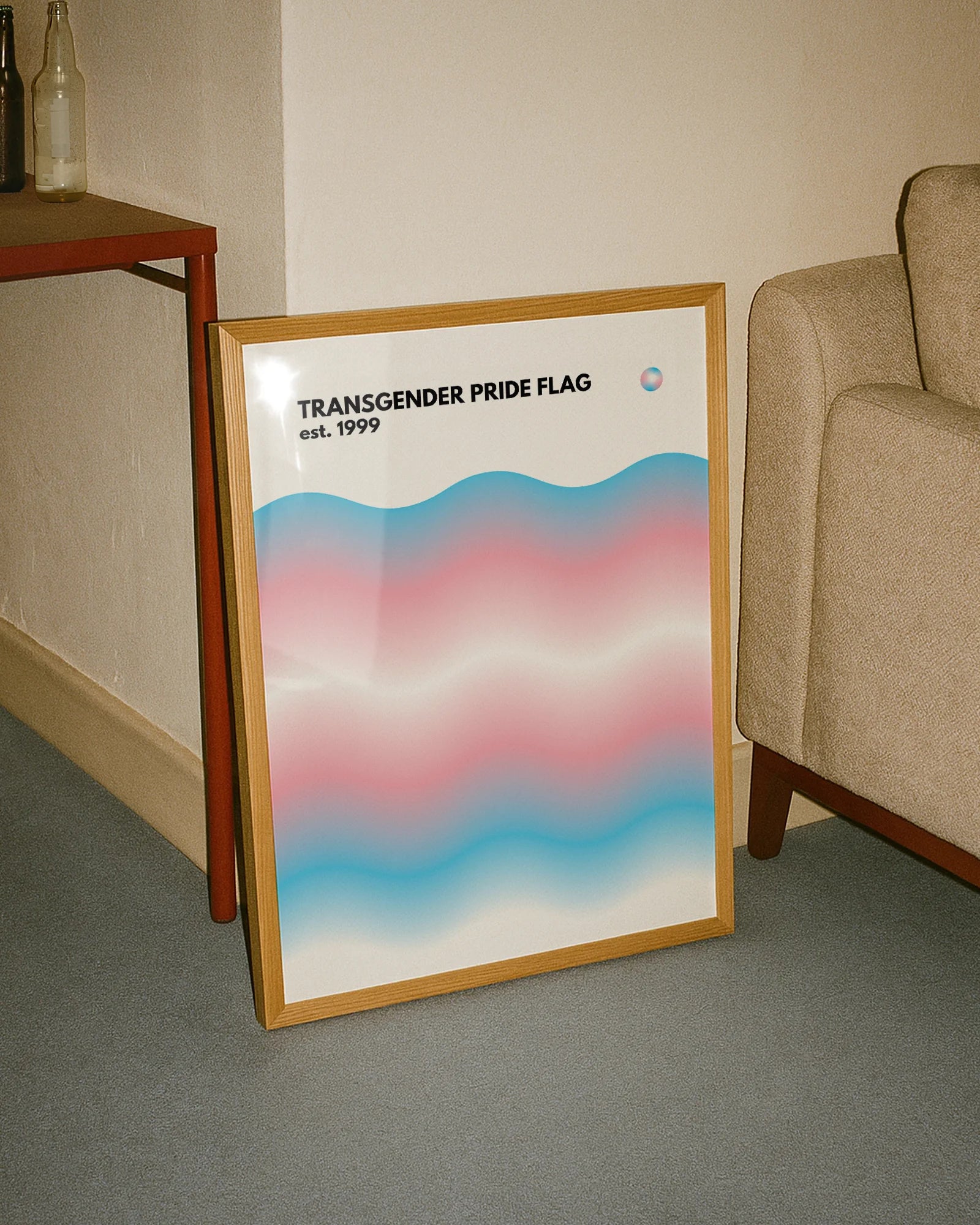 A print with the Transgender pride flag in a wavy, abstract form together with the text 'Transgender Pride Flag est. 1999.'