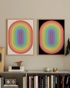 Two framed prints with an illustrative prideflag in an oval form.